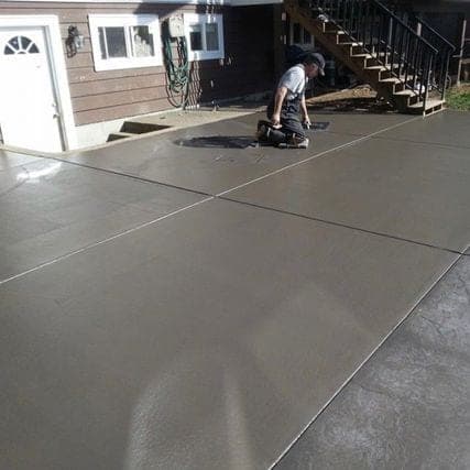 Comparison of a professionally sprayed and back-rolled concrete driveway sealer application versus a roller-applied DIY coat