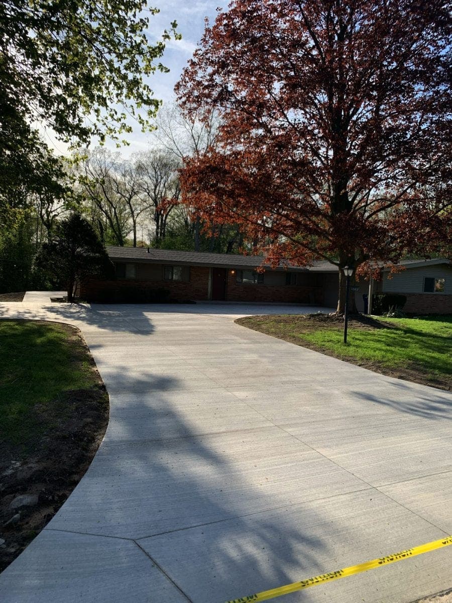 Broom finish concrete driveway at a ranch home in autumn