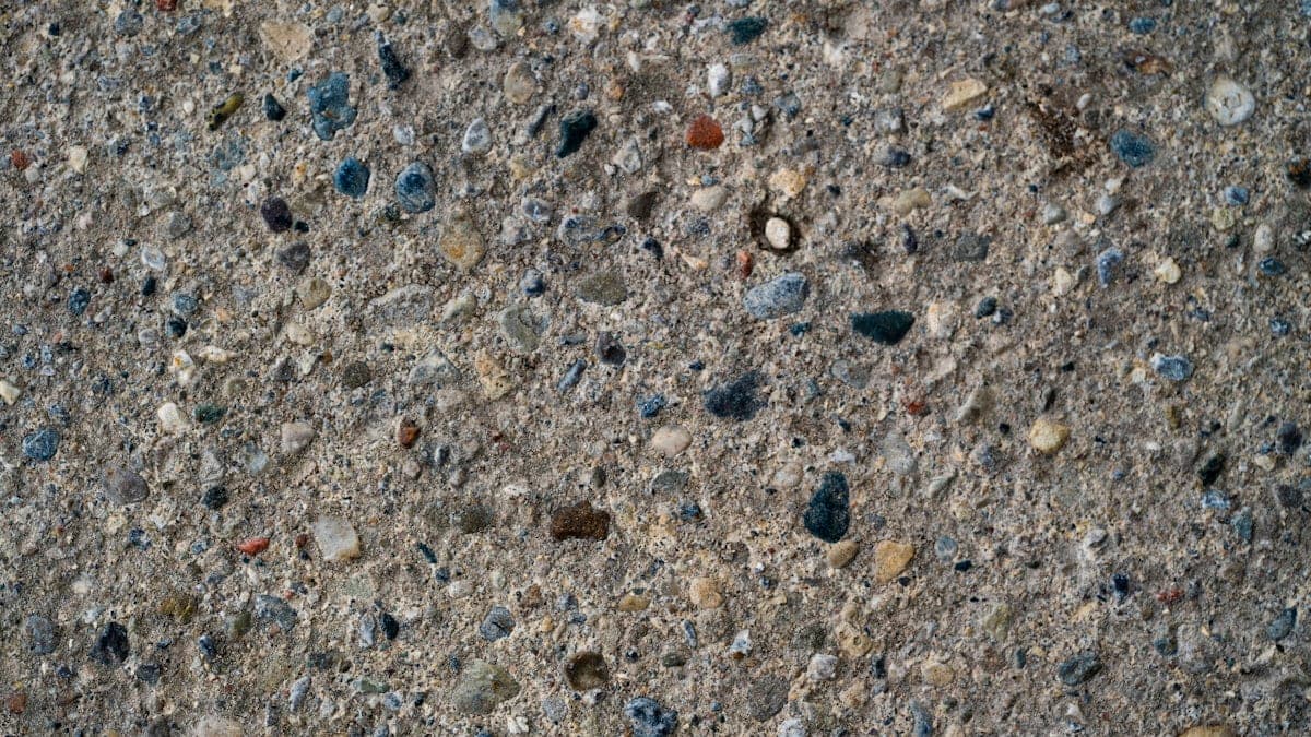 Close-up of sealed exposed aggregate concrete showing enhanced stone colour