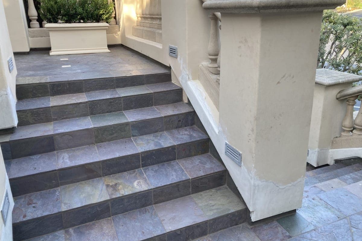 Textured non-slip sealed concrete patio surface with visible grip texture near a pool edge