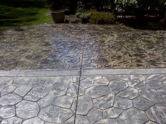 Two-tone stamped concrete driveway with a gloss sealer finish by TriCity Concrete Sealing